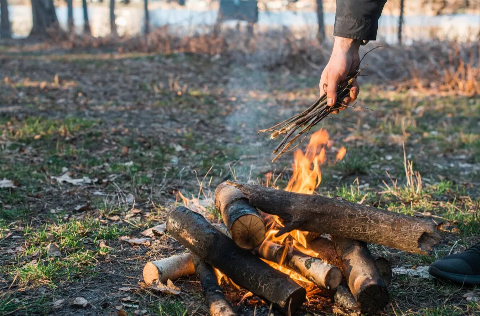 Choose dry, seasoned firewood for a safe and efficient campfire. Collect from the ground, avoid damp wood, and organize into tinder, kindling, and logs for easy ignition.